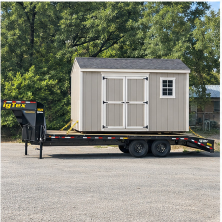 Small shed secured on a dual-axle gooseneck trailer for transport