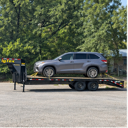 SUV secured on Quick K Transport gooseneck trailer for vehicle transport in Texas